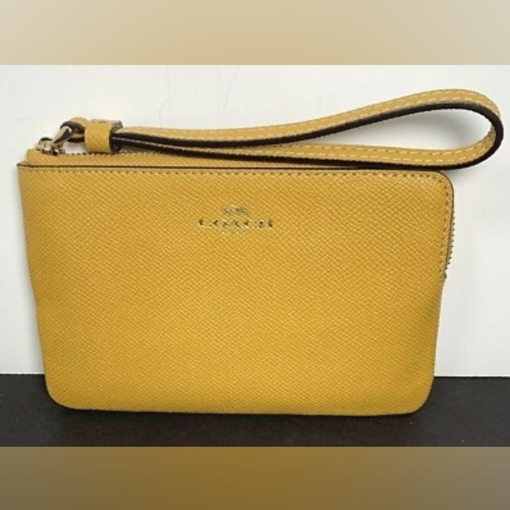 Yellow COACH wristlet
